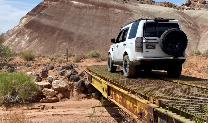photo of a white Land Rover LR4 in a mountain setting