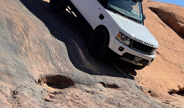 photo of a white Land Rover LR4 in a mountain setting