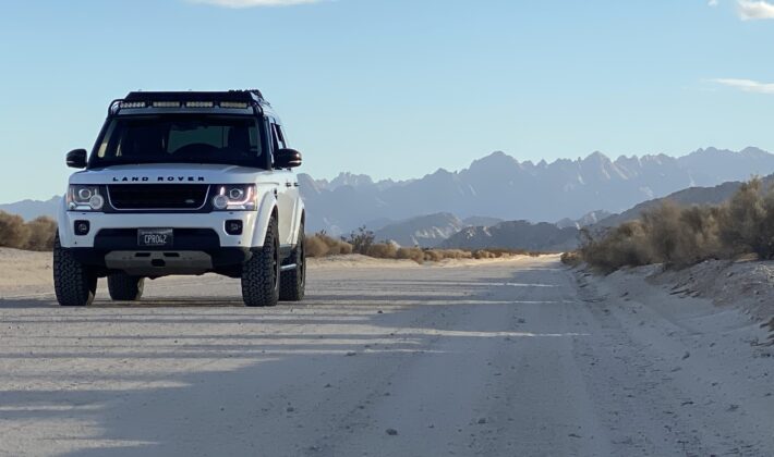 photo of a white Land Rover LR4 in a mountain setting