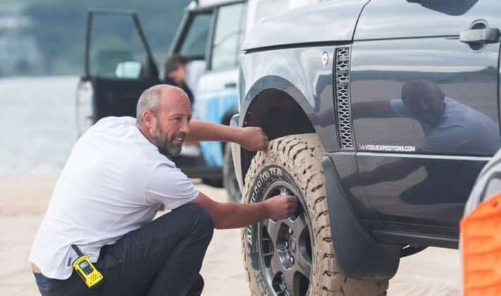 someone changing the tire pressure on a Range Rover