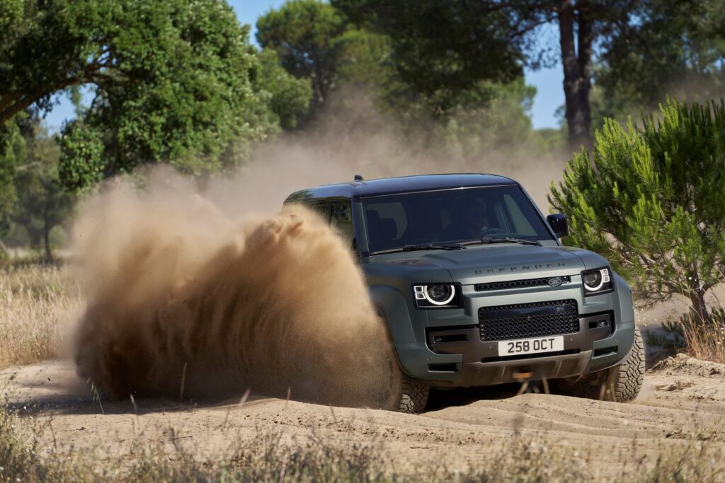 image of a Land Rover Defender OCTA driving through dirt