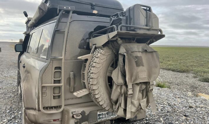 photo of the rear of a mud-covered Land Rover Defender 110