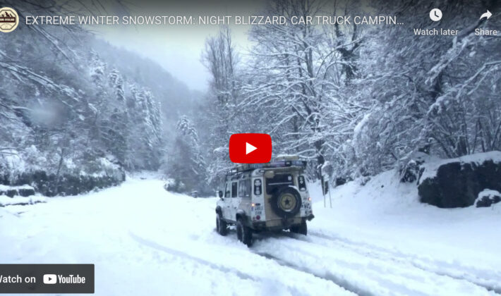 video cover image of a classic Land Rover Defender driving in snow