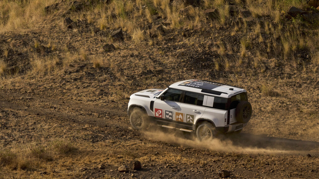 aerial image of a Defender 110 driving on a dirt road