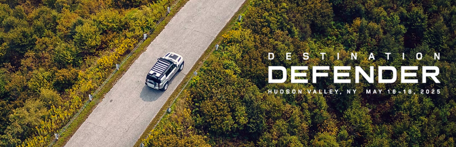 aerial image of a Land Rover Defender driving on a road